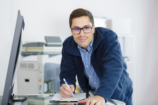man technician repairing a printer at business place at work