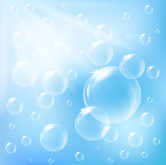 Bright bubbles floating on blue background