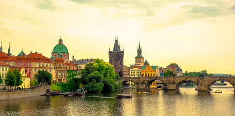 Fototapeta na wymiar Sunset Landscape of the romantic city of Prague.Panoramic view of Charles bridge and old town on a summer day in the capital Czech Republic. Cruise on the Moldovan river.