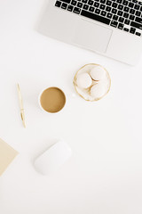 Flat lay modern workspace with laptop, macaroons, coffee mug. Top view lifestyle concept.