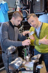 young shop assistant selling at a golf shop