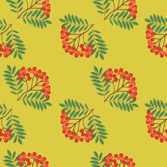 Seamless colorful autumn pattern with rowan and green leaves on a yellow background. Floral rowan illustration for print.