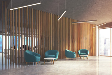 Waiting area in office, blue armchairs, side