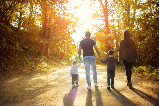 Happy family walking in the forest