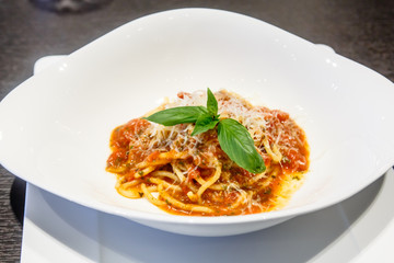 Pasta (spaghetti) with tomato is on the plate.