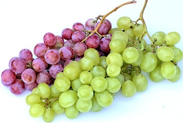 Ripe white and red grapes on a white background.