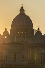 Fototapeta premium Rome, Italy. Vatican dome of Saint Peter Basilica (San Pietro) and Sant'Angelo Bridge, over Tiber river at sunset. One of the most famous view in the World. One of the most famous view in the World