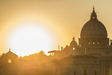 Rome, Italy. Vatican dome of Saint Peter Basilica (San Pietro) and Sant'Angelo Bridge, over Tiber river at sunset. One of the most famous view in the World. One of the most famous view in the World