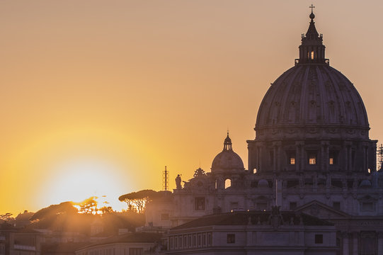 Rome, Italy. Vatican dome of Saint Peter Basilica (San Pietro) and Sant'Angelo Bridge, over Tiber river at sunset. One of the most famous view in the World. One of the most famous view in the World
