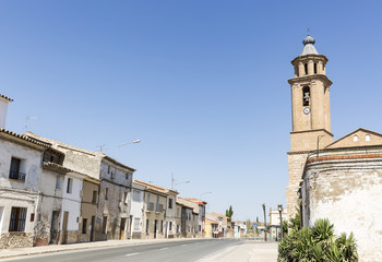 Fototapeta na wymiar street and La Asuncion church in Candasnos town, province of Huesca, Aragon, Spain