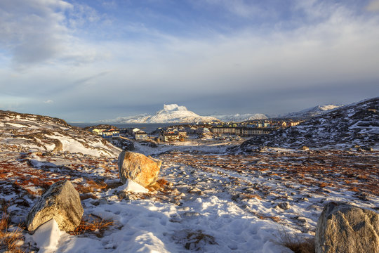 Daylight view to the distant houses of suburb of Nuuk city, with Sermitsiaq mountain in the background, Greenland