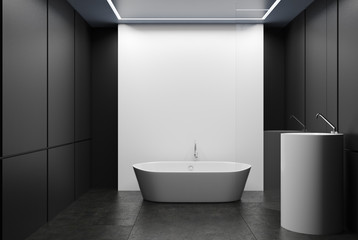 Obraz na płótnie Canvas Gray and white tiled bathroom, tub and sink