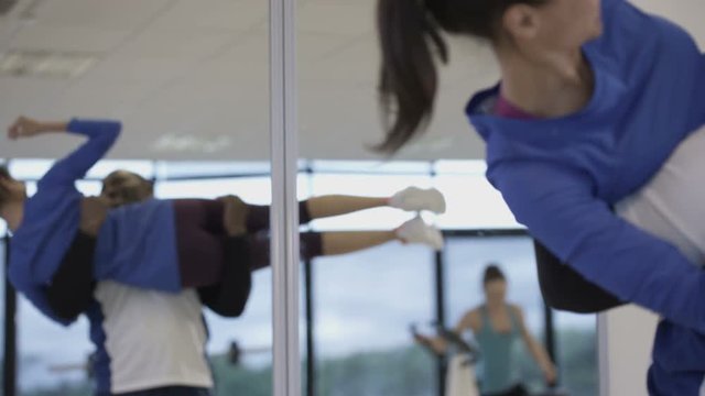 Happy couple working out in the gym, man lifting his partner like a weight