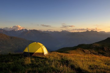 Fototapeta na wymiar Tent in front of a mountain range in the last daylight, Gaschurn, Montafon, Vorarlberg, Austria, Europe