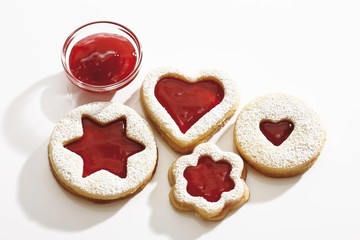 Short pastry jam biscuits, strawberry jam in a glass bowl