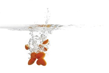 Kumquats dropping into water