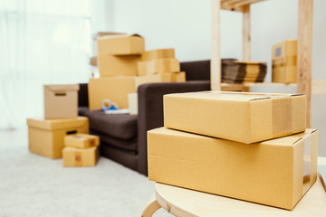 Arrangement of empty cardboard packing boxes standing on a floor with copy space, SME delivery, moving house concept