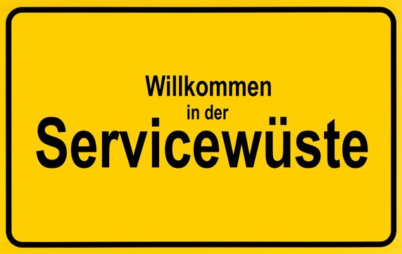 Town sign, German lettering Willkommen in der Servicewueste, symbolic of lack of service