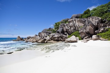 Lonely beach of Grand Anse, with the typical granite rocks of La Digue, La Digue Island,...