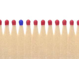 Blue matchhead among a row of red matches, symbolic image for being different