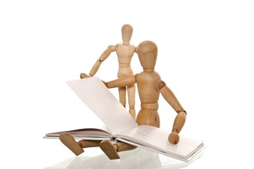 Mannequin reading a book to a smaller mannequin