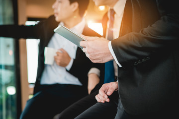 A group of men are businessmen sit together and succeeded in finding the various agreements.