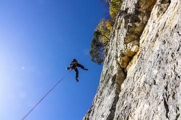 Obraz premium Climber abseiling, Schauenburgfluh Mountain, Basel Jura, canton of Basel Country, Switzerland, Europe
