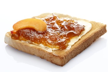 Slice of toast, toasted slice of bread, with apricot jam and apricot pieces