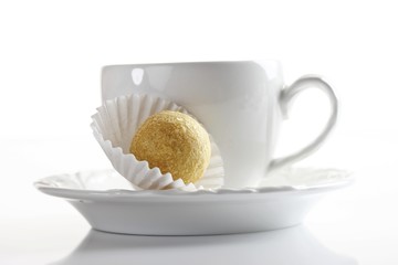 Coffee cup and a truffle chocolate