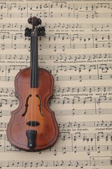 Fototapeta premium Toy violin in front of music sheet