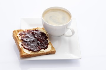 Porcelain plate with a cup of coffee and toast with rosehip and apple jam