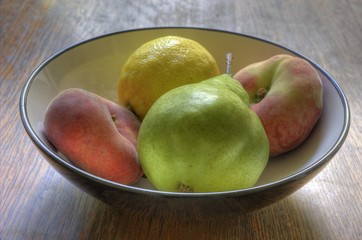 Naklejka na ściany i meble Dish with white peaches, a pear and a lemon