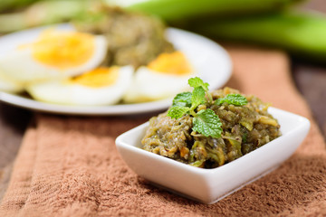Northern Thai food (Tum Makeua Yao).Grilled green eggplant pounding with chili and spices and eating with boiled egg