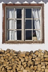 Window with pile of wood, Achenkirch, Tyrol, Austria, Europe