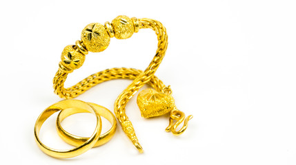 Thai style gold jewelry bracelet and couple gold ring isolated on white background with copy space,...
