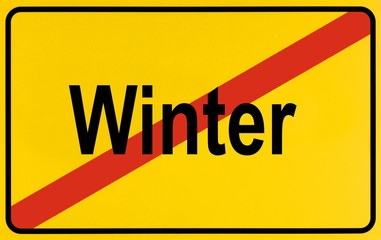 Fototapeta premium Town exit sign, lettering Winter, symbolic of end of winter