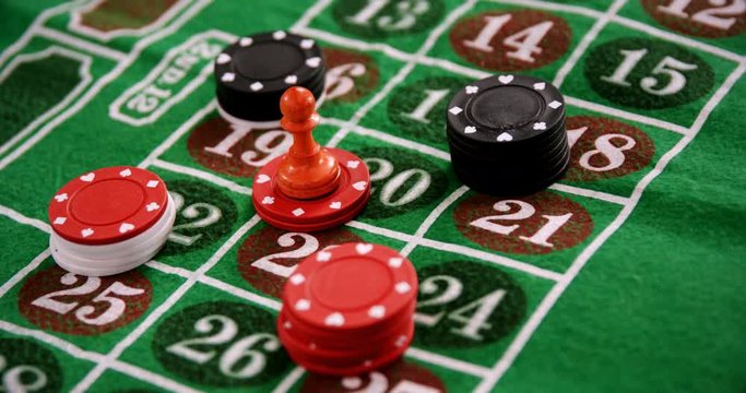 Casino chips on roulette on poker table 