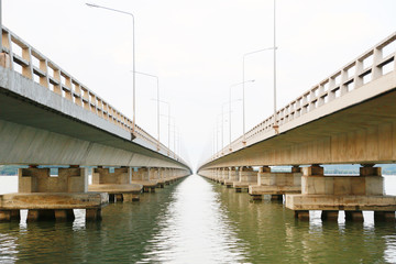 Long bridge cross over the big river or the sea for support transportation and travel between land or the city. The bridge under engineering design and designed by modern design.