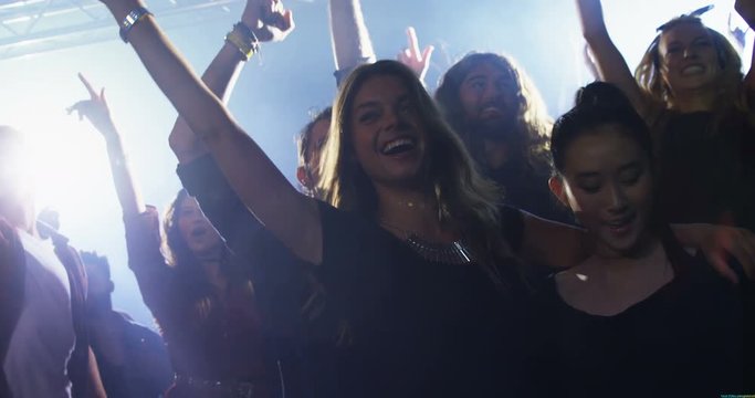 Group of people dancing at a concert 