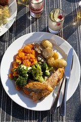 Grilled salmon with vegetables, broccoli, carrots, potatoes with rosemary and lime sorbet as dessert