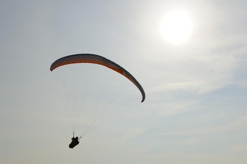 Paraglider in front of the sun