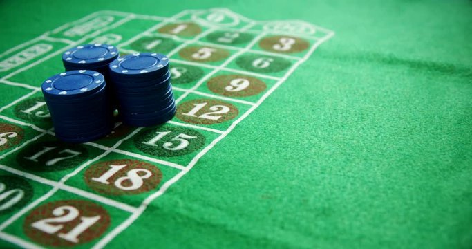 Casino chips on roulette on poker table 