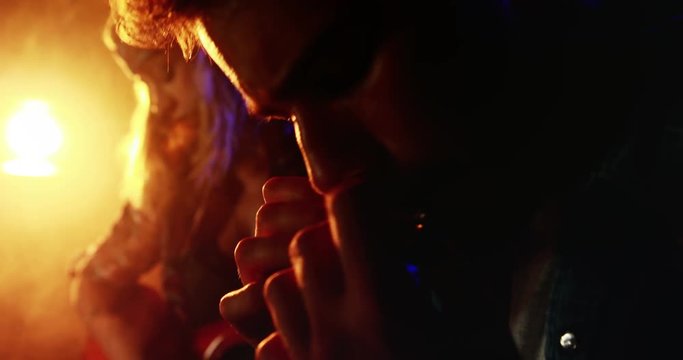 Couple playing guitar and harmonica 