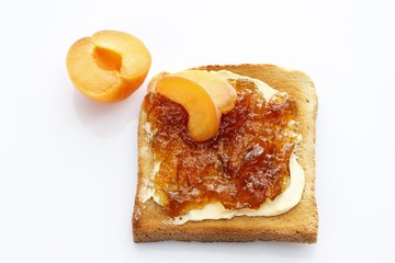 Slice of toast, toasted slice of bread, with apricot jam and apricot pieces