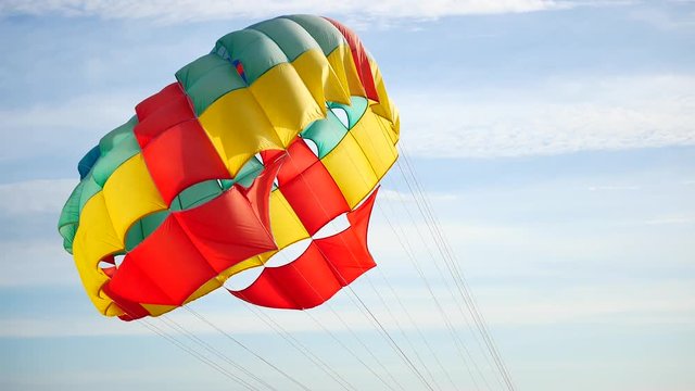 Close up Colorful parasailing provide services to tourists on sky in sunset time in travel and transport concept.