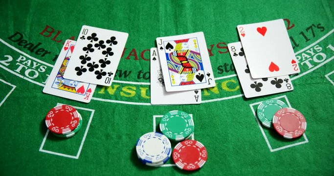 Casino chips and playing cards on roulette in casino 