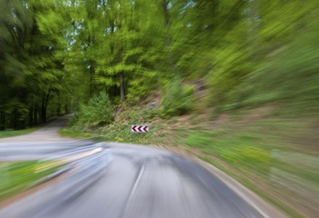Obraz premium High speed motion, country road in a wooded area with a sharp left turn, Germany, Europe, PublicGround, Europe
