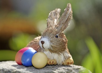 Easter bunny figure with brightly coloured Easter eggs