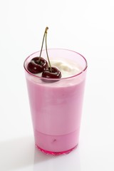 Pink cup with yoghurt and cherries