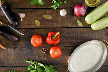 Different vegetables on a wooden table, top view
